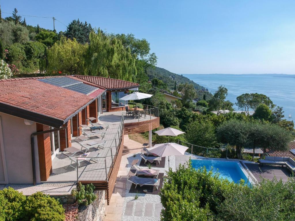 a villa with a swimming pool and a resort at Villa Vela in Torri del Benaco