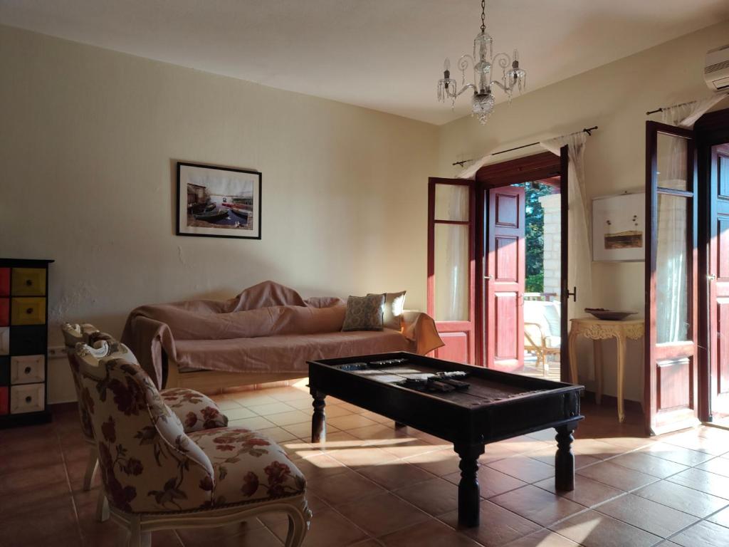 a living room with a couch and a coffee table at Alkyon Villas in Syvota