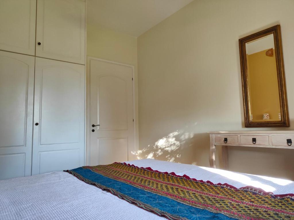 a bedroom with a bed with a mirror and a dresser at Alkyon Villas in Syvota
