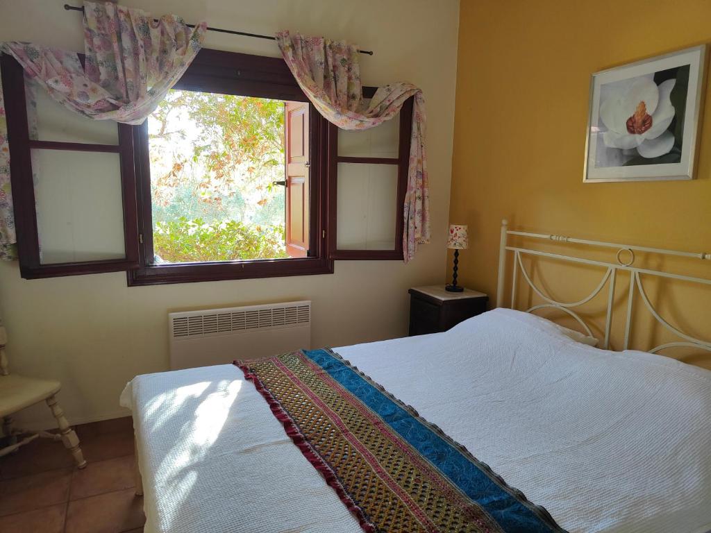 a bedroom with a bed and a window at Alkyon Villas in Syvota