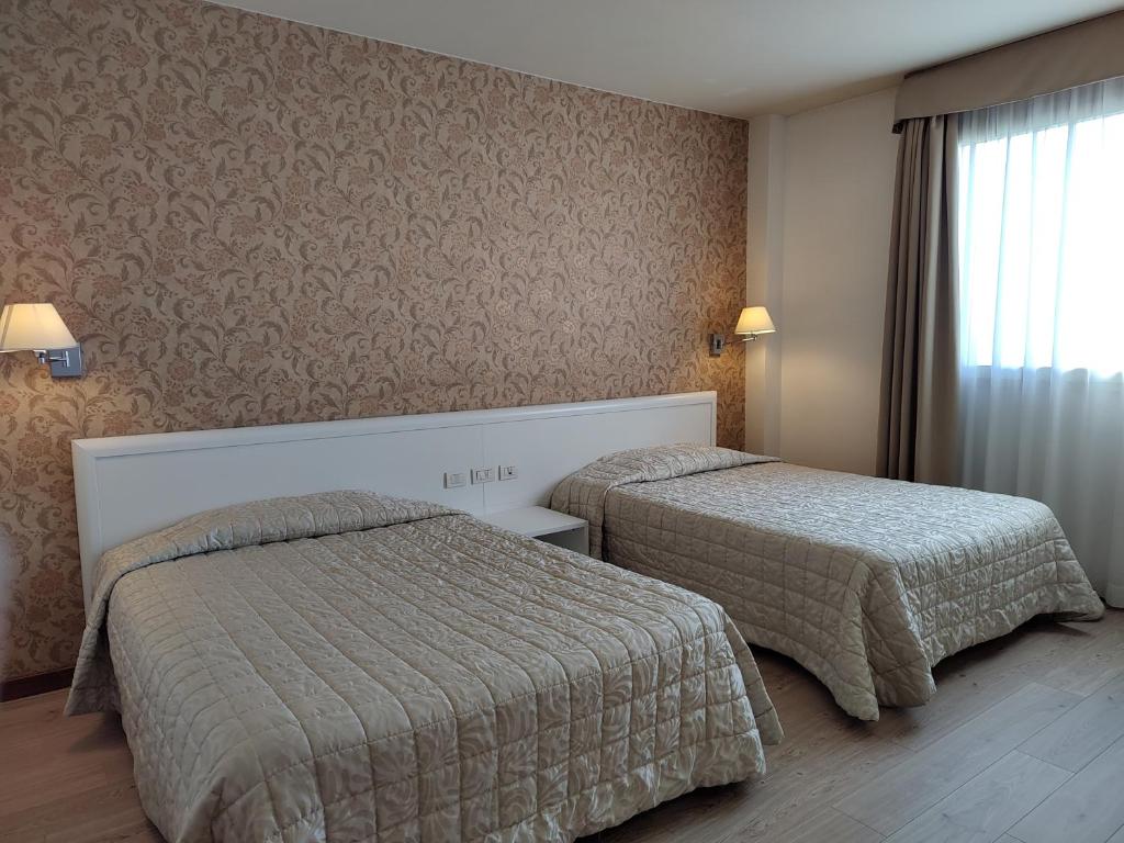 Posteľ alebo postele v izbe v ubytovaní Hotel Datini