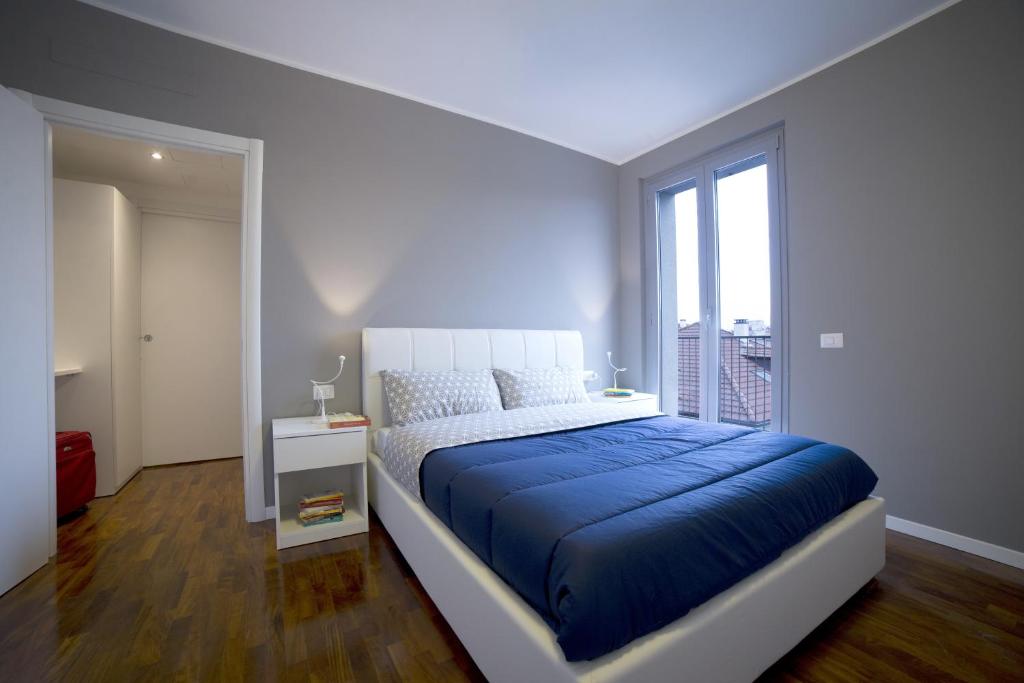 a bedroom with a blue bed and a window at Dreams Hotel Residenza Pianell 10 in Milan