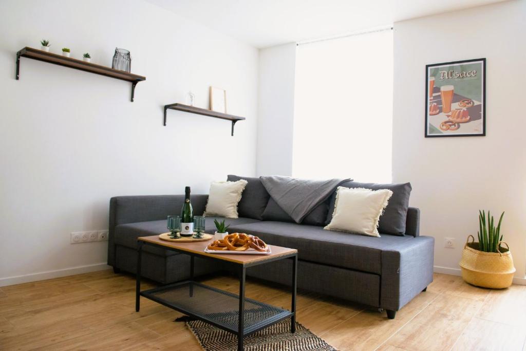 a living room with a couch and a table at La Pomme du Président I in Sélestat