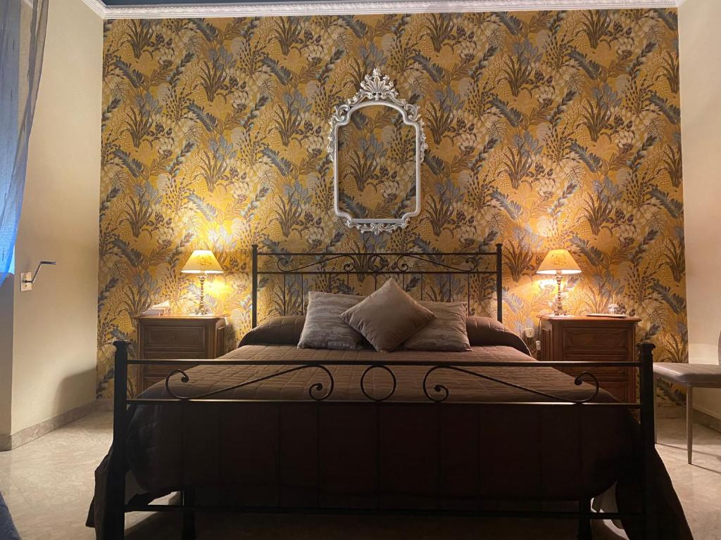 レッチェにあるLa Dimora di Vestaのベッドルーム1室(金の壁紙のベッド1台付)