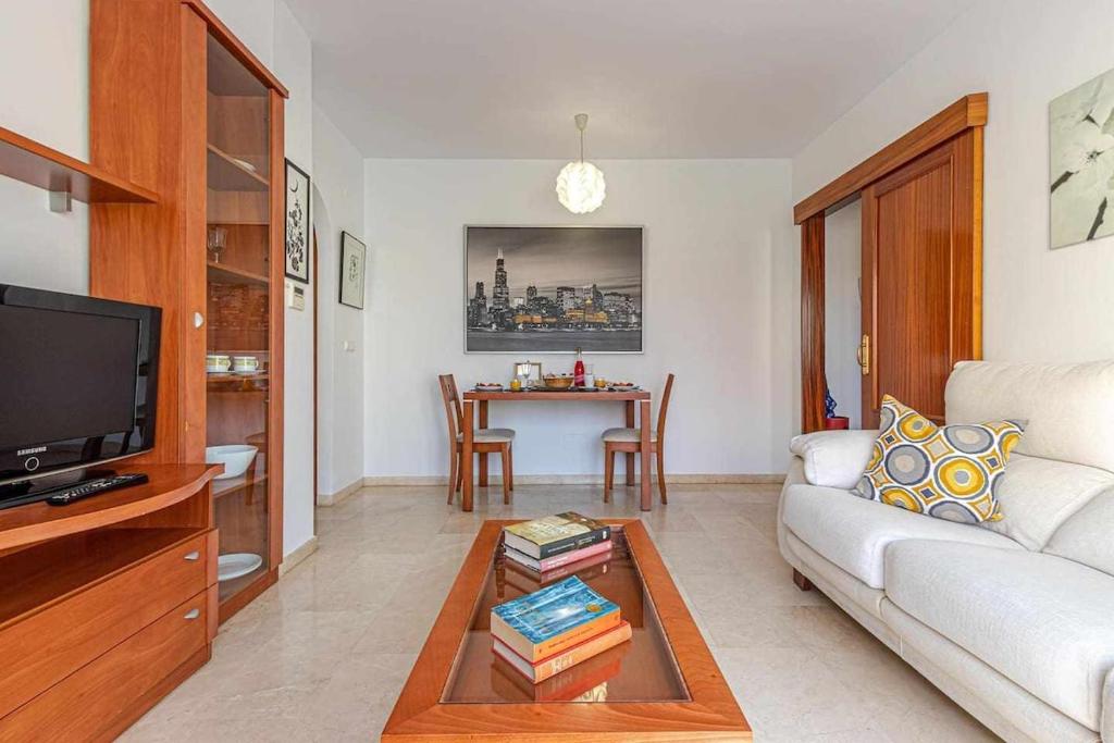 a living room with a couch and a table at 797 Holiday Rentals - Elegante apartamento para 2 en Torremolinos. in Torremolinos