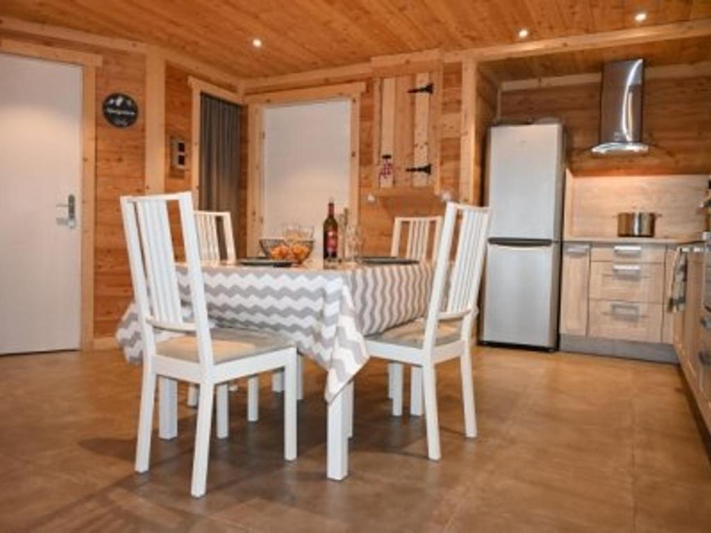 a kitchen with a table and chairs and a refrigerator at Appartement Montgenèvre, 3 pièces, 6 personnes - FR-1-266-164 in Montgenèvre