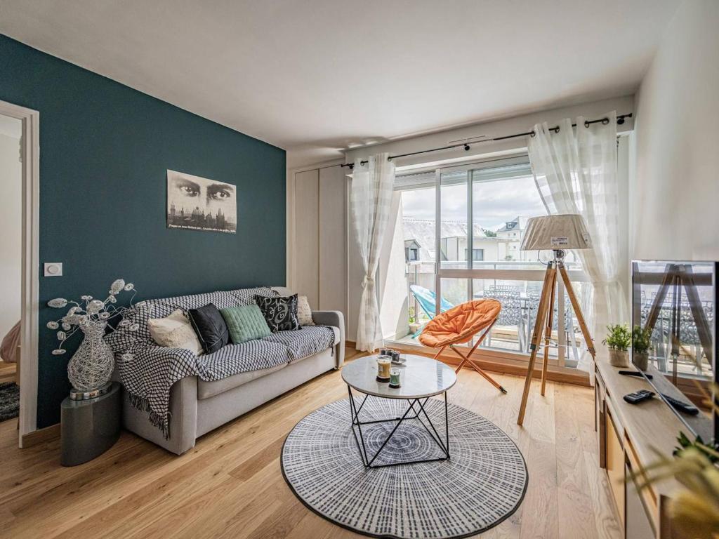 a living room with a couch and a table at Appartement Bénodet, 2 pièces, 4 personnes - FR-1-481-80 in Bénodet