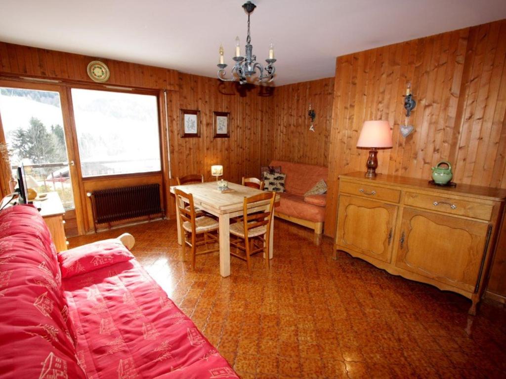 a living room with a table and a couch at Studio Le Grand-Bornand, 1 pièce, 4 personnes - FR-1-458-89 in Le Grand-Bornand