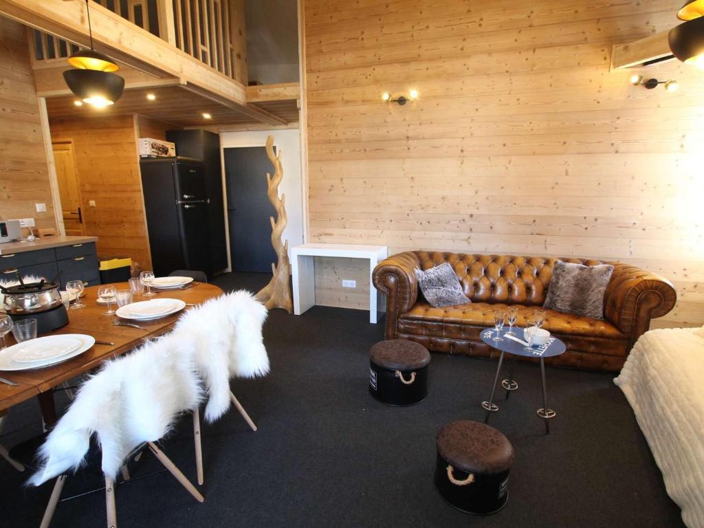 ein Wohnzimmer mit einer Couch und einem Tisch mit weißen Federn in der Unterkunft Appartement rénové 4 pièces avec mezzanine et 3 chambres, au cœur de Briançon, proche commerces et télécabine - FR-1-330C-118 in Briançon