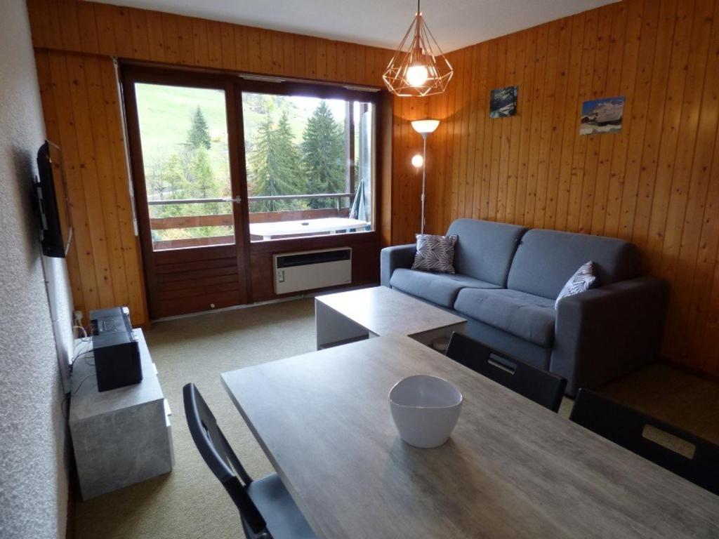 a living room with a table and a couch at Studio Le Grand-Bornand, 1 pièce, 4 personnes - FR-1-458-113 in Le Grand-Bornand