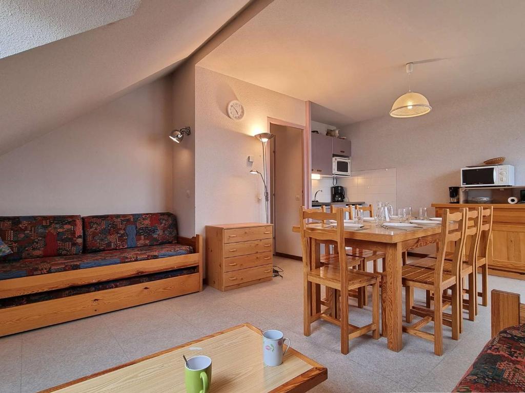 a living room with a table and a couch at Appartement Le Dévoluy, 2 pièces, 6 personnes - FR-1-525-178 in Le Dévoluy