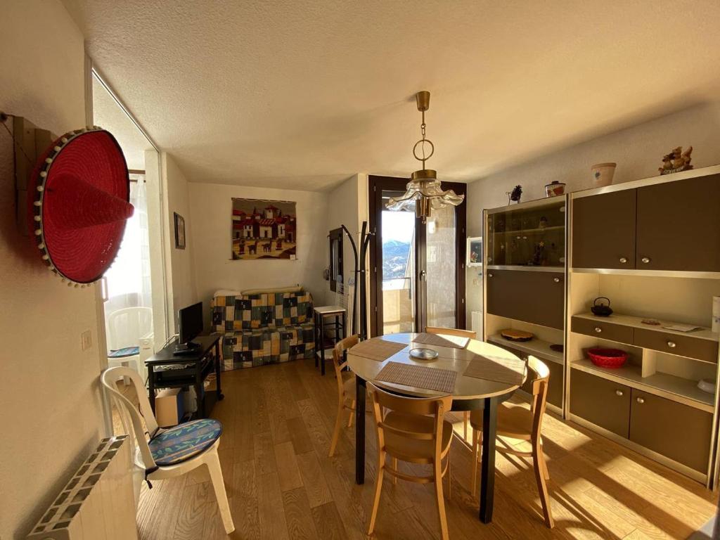 a kitchen with a table and chairs in a room at Appartement Les Angles, 2 pièces, 4 personnes - FR-1-295-169 in Les Angles