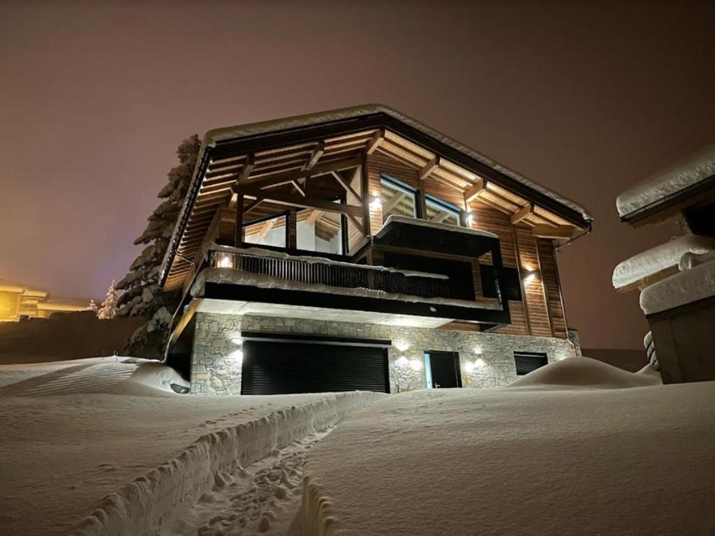 a building in the snow with snow footprints in front of it at Chalet Montvalezan-La Rosière, 6 pièces, 10 personnes - FR-1-398-633 in Montvalezan