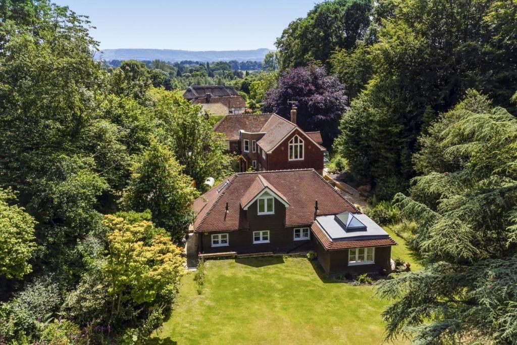 an aerial view of a house in the forest at Little Vintners in Thakeham