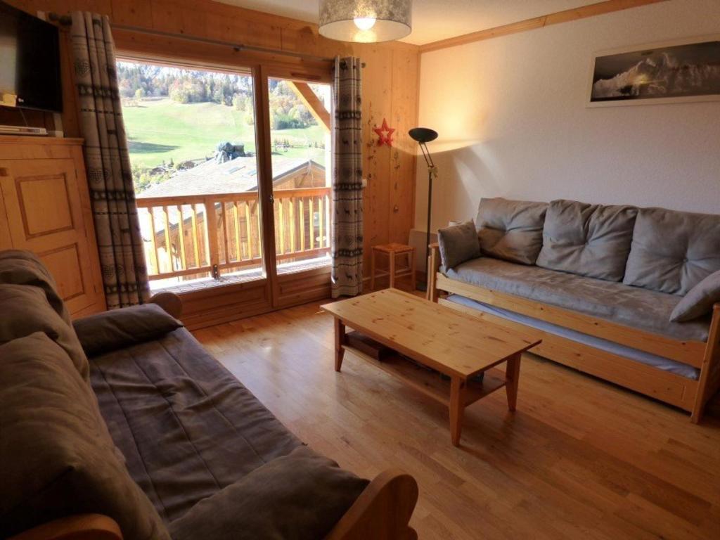 a living room with a couch and a coffee table at Appartement Le Grand-Bornand, 2 pièces, 6 personnes - FR-1-458-109 in Le Grand-Bornand