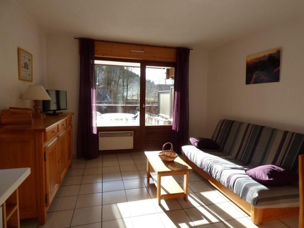 a living room with a couch and a window at Appartement Le Grand-Bornand, 3 pièces, 6 personnes - FR-1-458-118 in Le Grand-Bornand