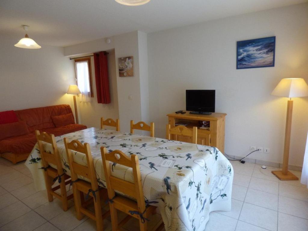 a living room with a dining room table and a couch at Appartement Saint-Jean-de-Sixt, 3 pièces, 6 personnes - FR-1-458-134 in Saint-Jean-de-Sixt