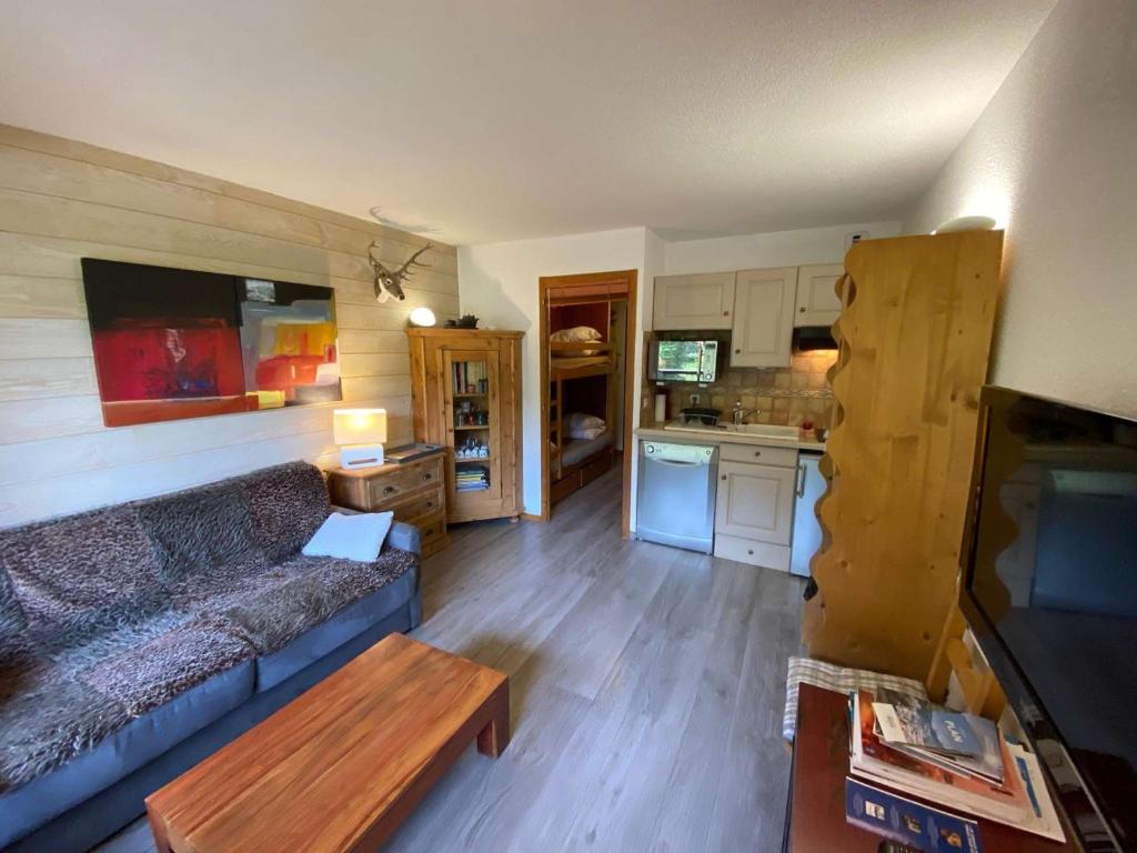a living room with a couch and a kitchen at Appartement Le Grand-Bornand, 1 pièce, 3 personnes - FR-1-241-238 in Le Grand-Bornand