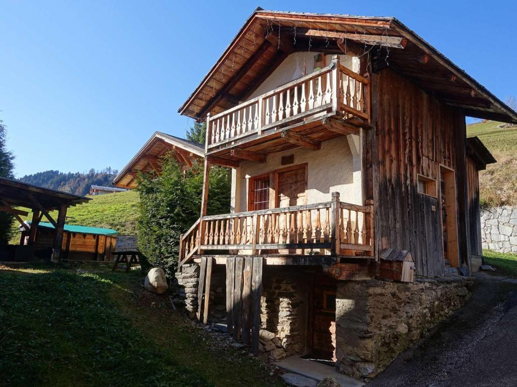a wooden house with a balcony on the side of it at Charmant Mazot Savoyard à Hauteluce: Idéal pour Couple, Proche Commerces et Ski, Bien Équipé - FR-1-342-263 in Hauteluce