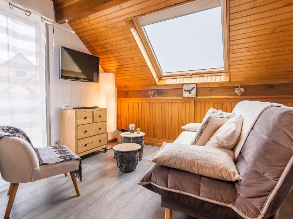 a living room with a couch and a window at Appartement Saint-Lary-Soulan, 2 pièces, 4 personnes - FR-1-296-359 in Saint-Lary-Soulan