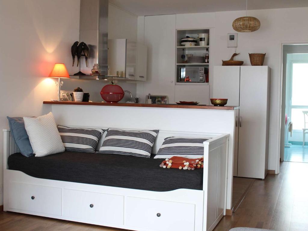 a white bed in a room with a kitchen at Appartement La Baule, 1 pièce, 4 personnes - FR-1-245-162 in La Baule