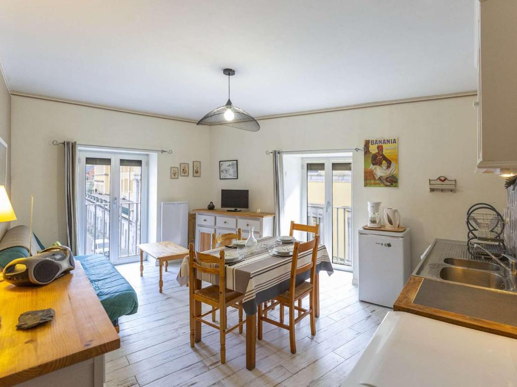 a kitchen and living room with a table and a kitchen and a dining room at Appartement Cauterets, 3 pièces, 4 personnes - FR-1-401-240 in Cauterets