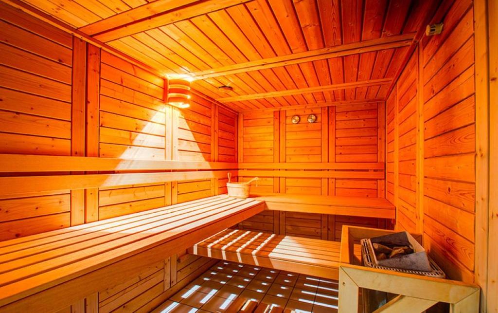 an empty wooden sauna with a bench in it at Studio L'Ecrin des Ecureuils in La Féclaz