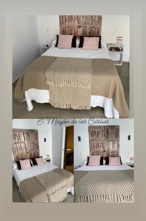a bedroom with a large bed with pink pillows at Alojamiento El Miajon de los Castúos in Valdesalor