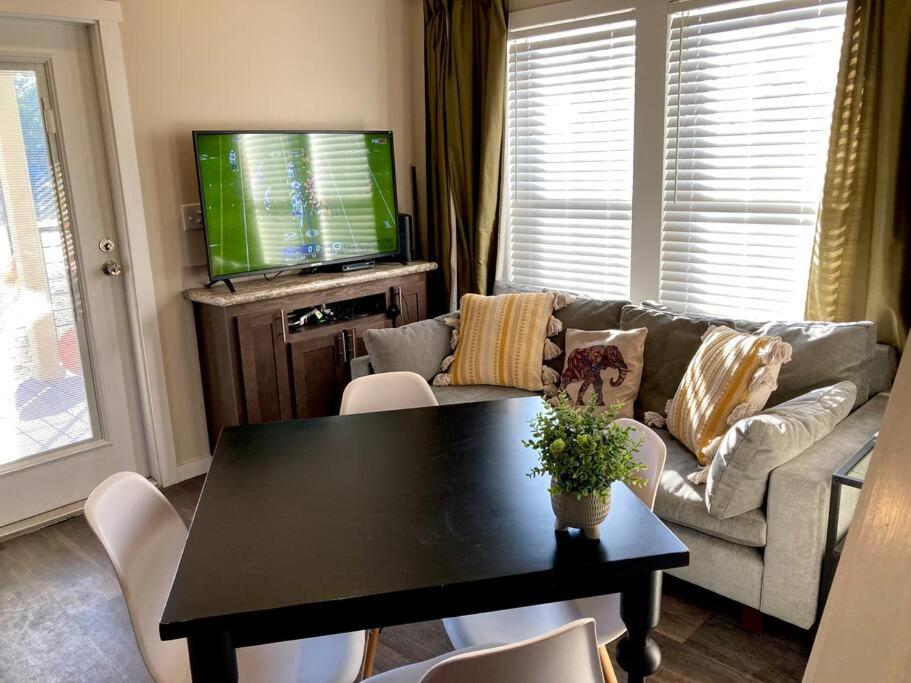 a living room with a table and a couch at Cozy Tiny Home in the Hills in Fischer