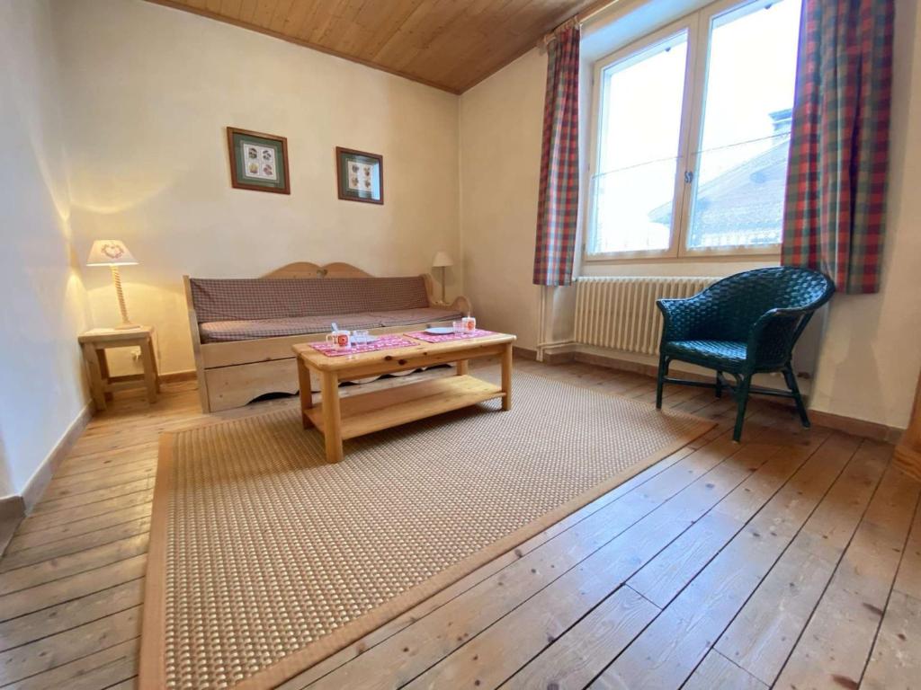 a room with a bed and a table and a chair at Appartement Praz-sur-Arly, 2 pièces, 4 personnes - FR-1-603-6 in Praz-sur-Arly