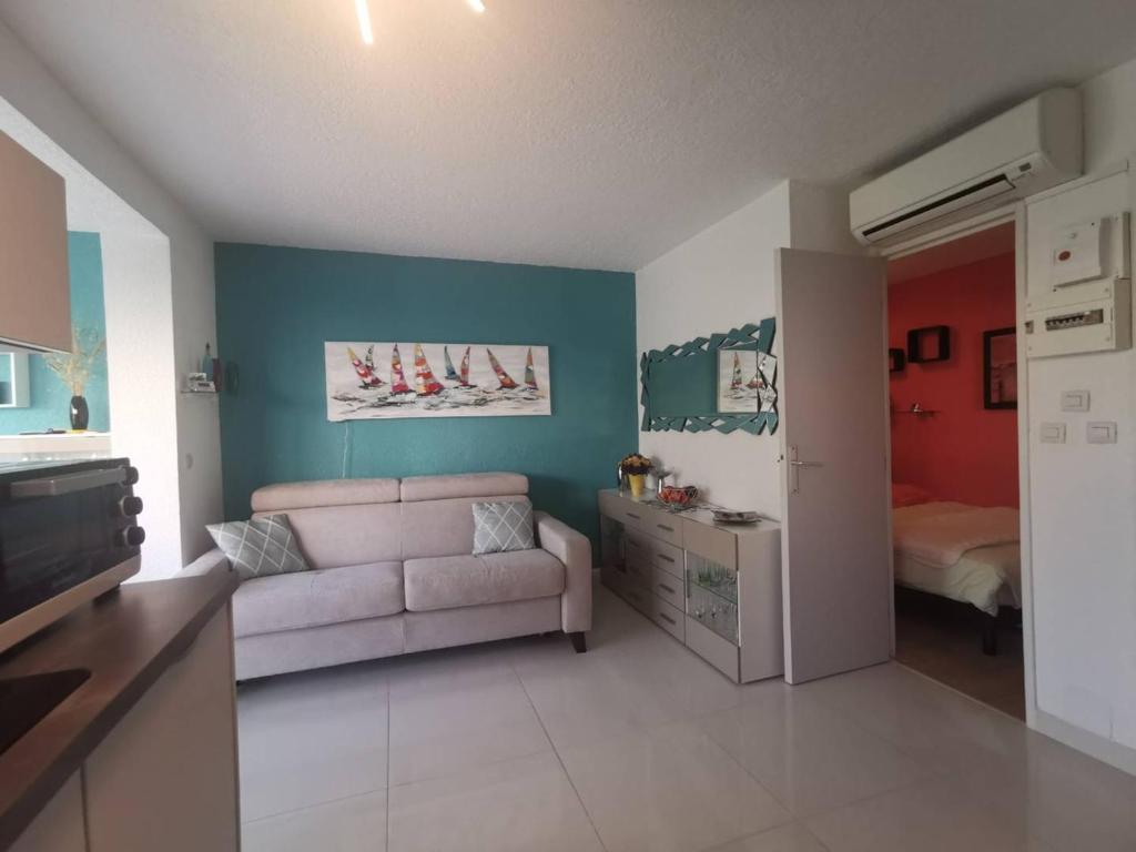- un salon avec un canapé et une chambre dans l'établissement Charmant T2 climatisé, proche mer, parking, terrasse, pour 2 personnes à Agde - FR-1-607-109, au Cap d'Agde
