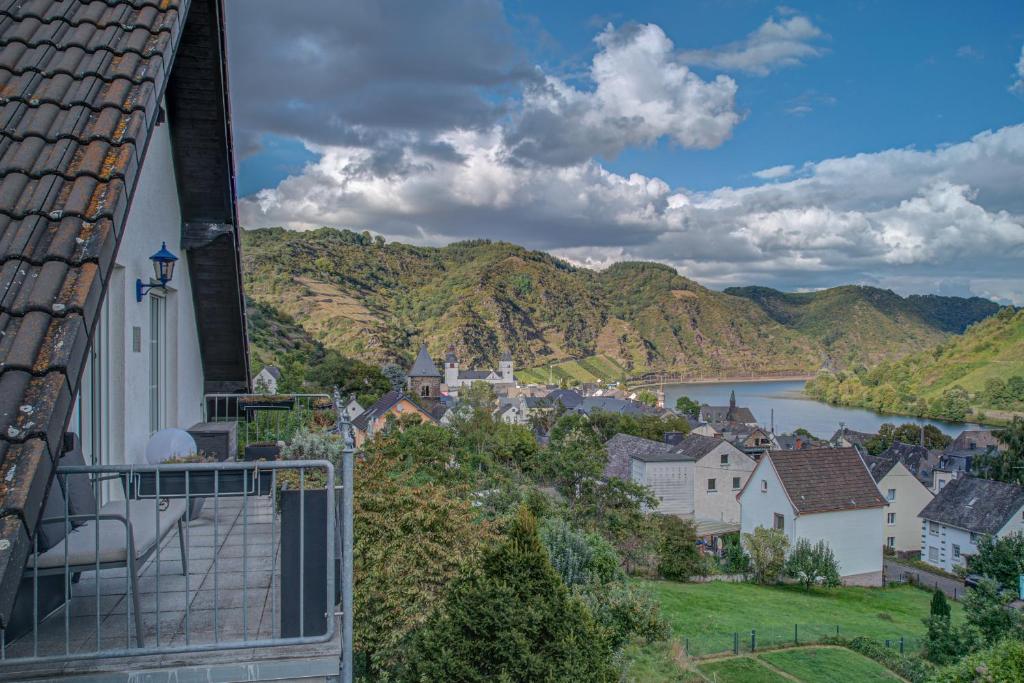 a view of a town with a river and mountains at Ferienwohnung Panorama Moselblick in Treis-Karden