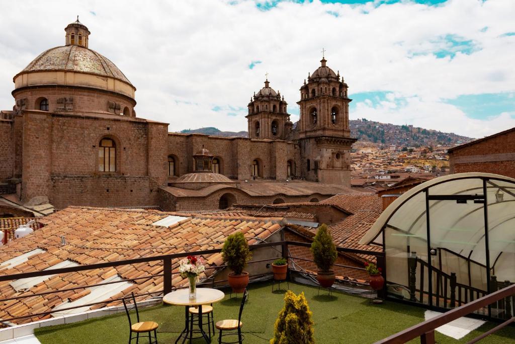 a view from the roof of a building with two towers at Hotel Santa Maria in Cusco