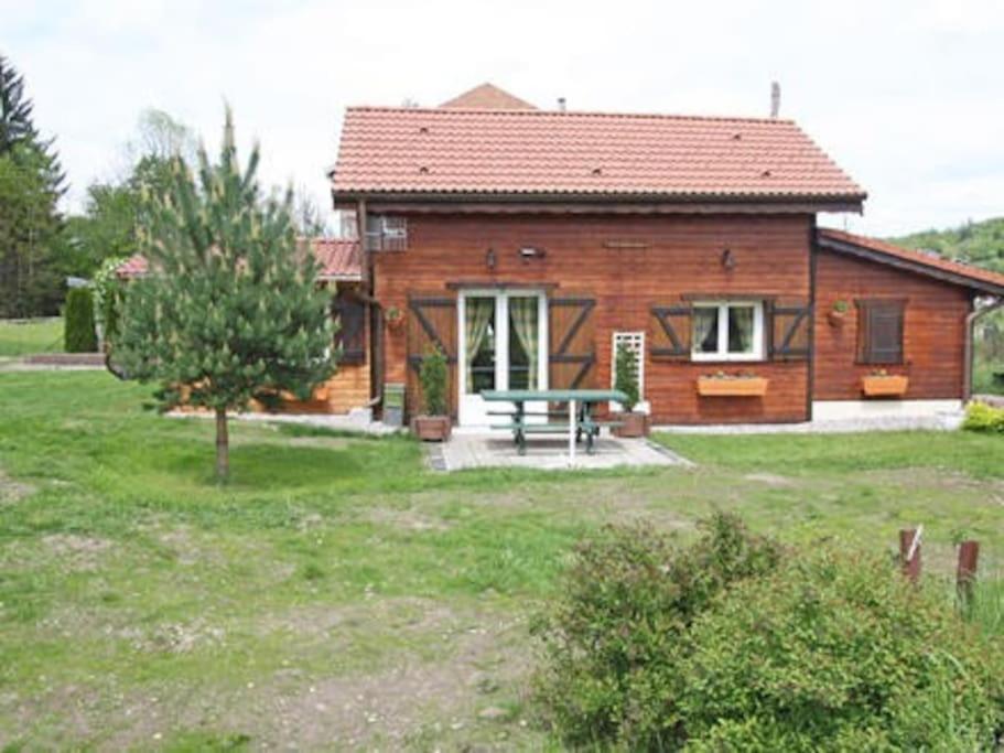 a house with a picnic table in front of it at chalet de montagne in Vagney