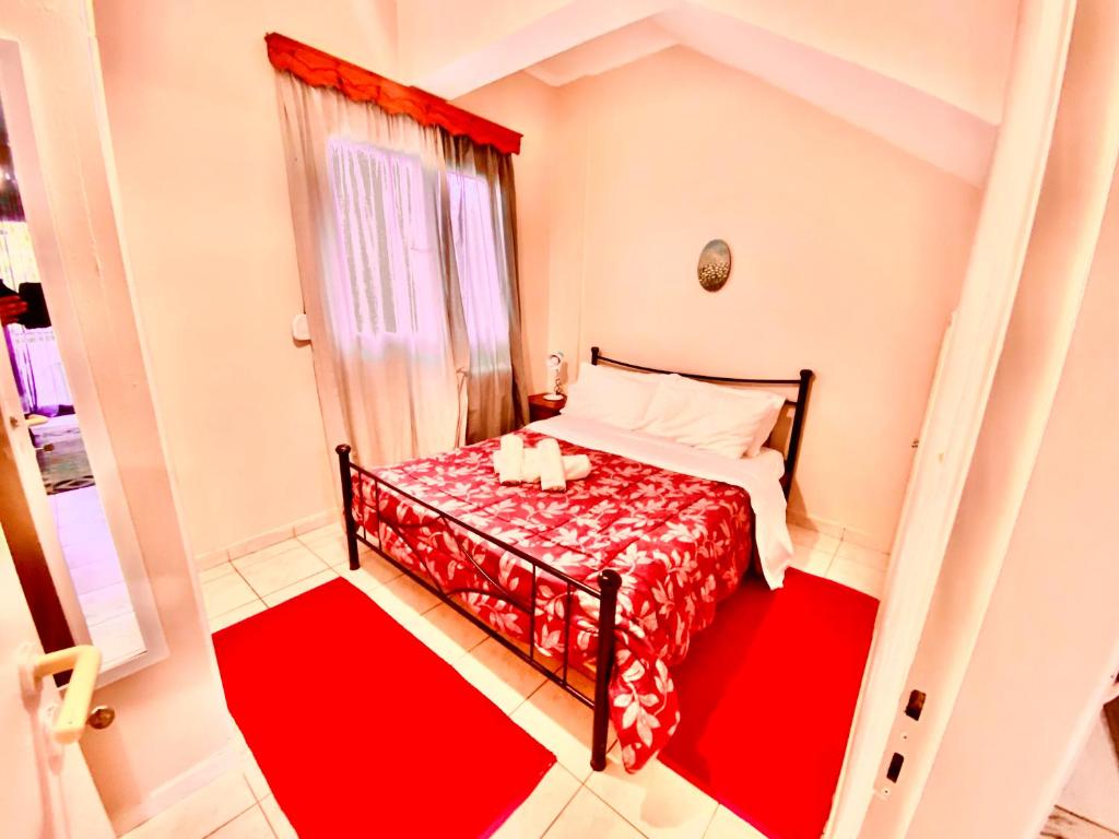 a small bedroom with a red and white bed at Feel Home Studio in Mytilene