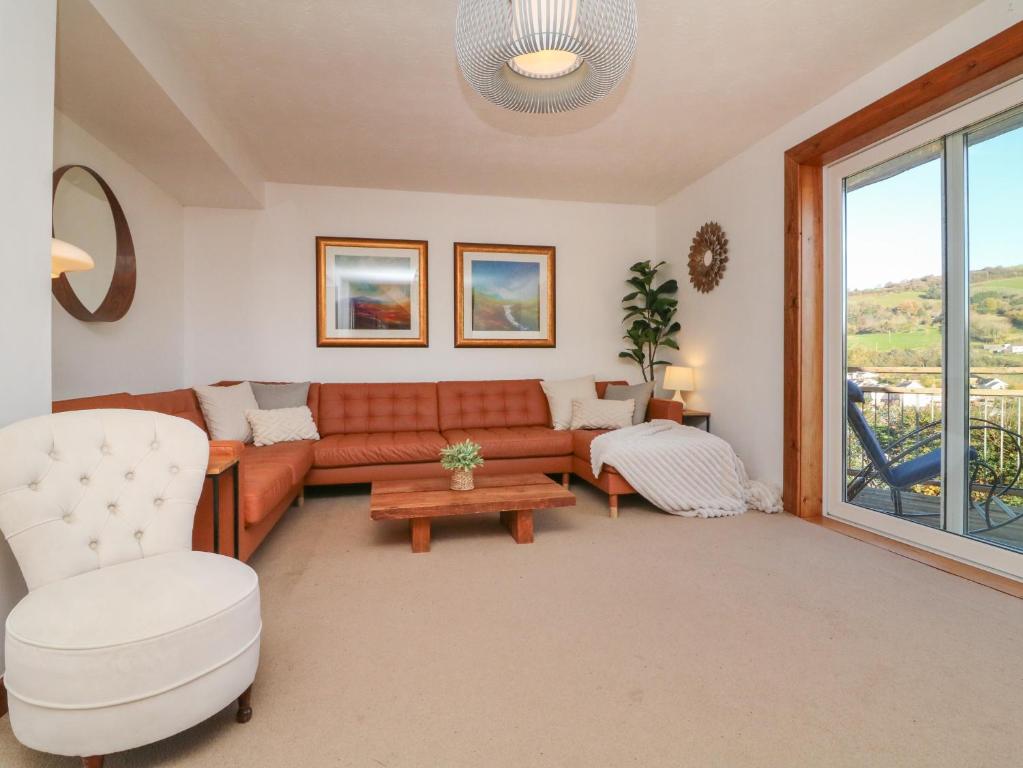 a living room with a couch and a table at Hillsview in Ilfracombe