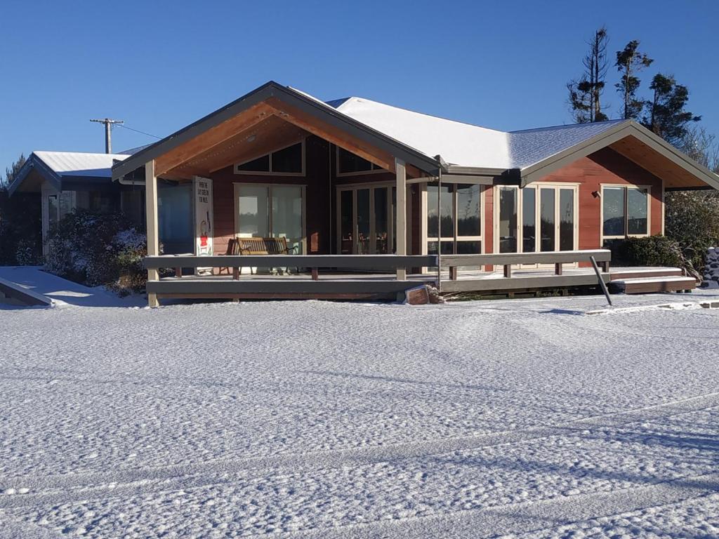 a house sitting on top of a gravel driveway at Tongariro Estate in National Park