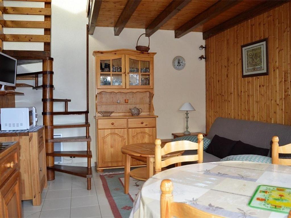 a living room with a staircase and a table at Chalet Bolquère-Pyrénées 2000, 3 pièces, 7 personnes - FR-1-592-27 in Bolquere Pyrenees 2000