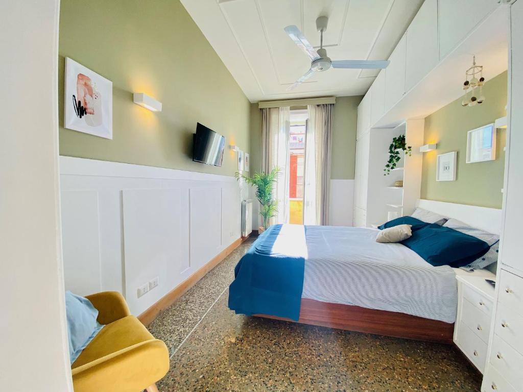 1 dormitorio con 1 cama, TV y silla en La Casa di Miele - Center Rome apartment, en Roma