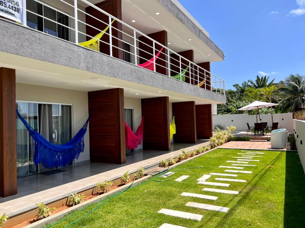 a large building with a lawn in front of it at VilaMar Jacuípe in Camaçari