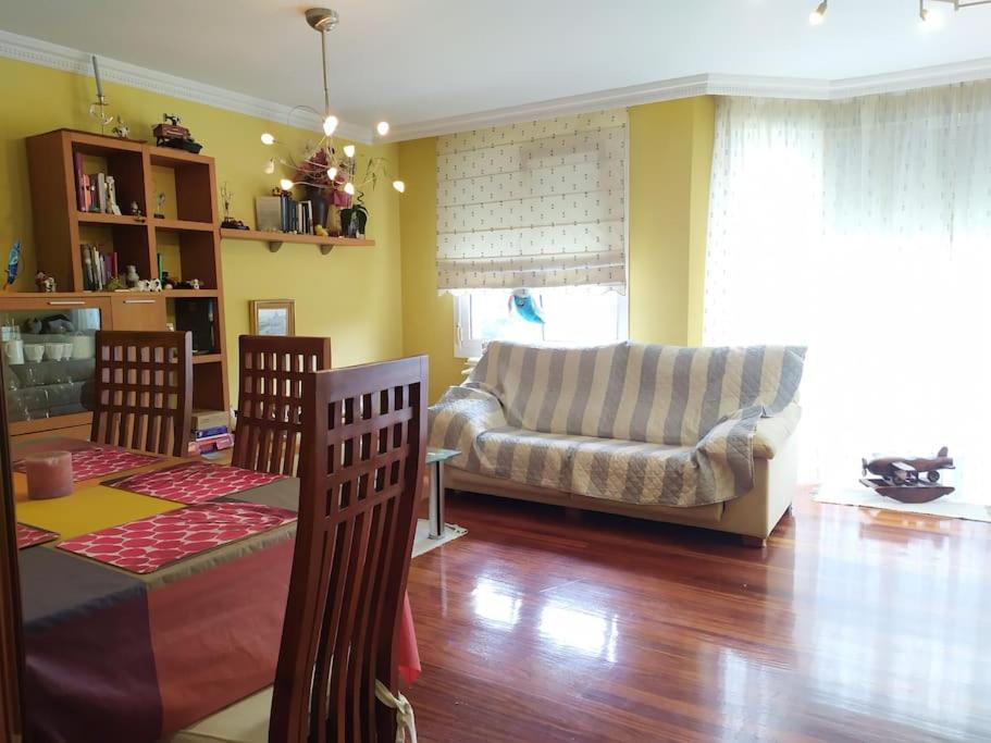 a living room with a couch and a table at TUS VACACIONES EN SANTANDER in Santander