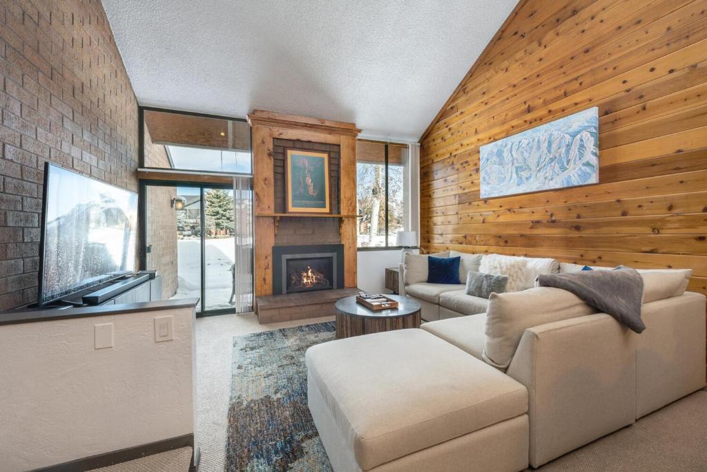 a living room with a couch and a fireplace at Two Bedroom Park Ave Condo by Lespri Property Management in Park City