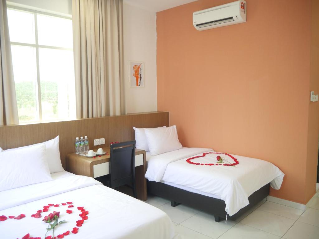 Postel nebo postele na pokoji v ubytování Hotel Wawasan