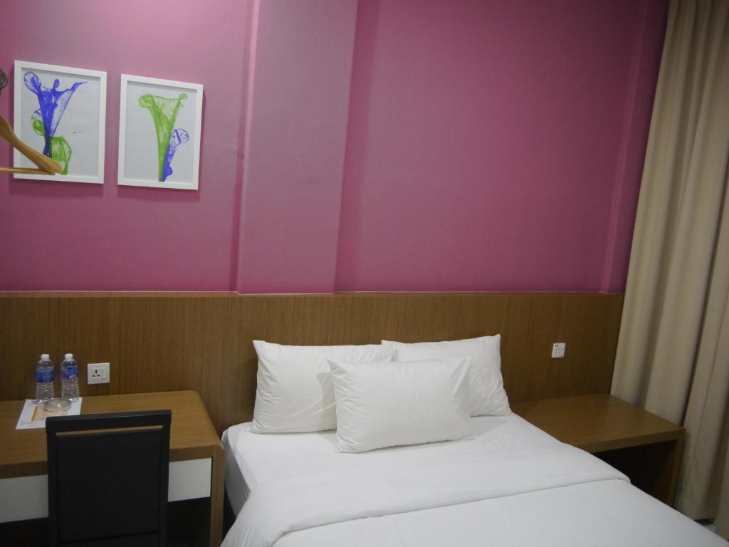 Postel nebo postele na pokoji v ubytování Hotel Wawasan