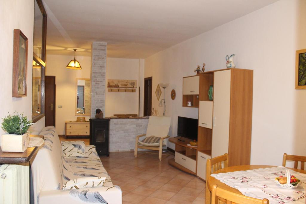 a living room with a couch and a dining room at Apartments Carisolo - Val Rendena in Carisolo