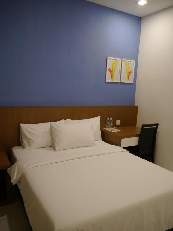 Postel nebo postele na pokoji v ubytování Hotel Wawasan