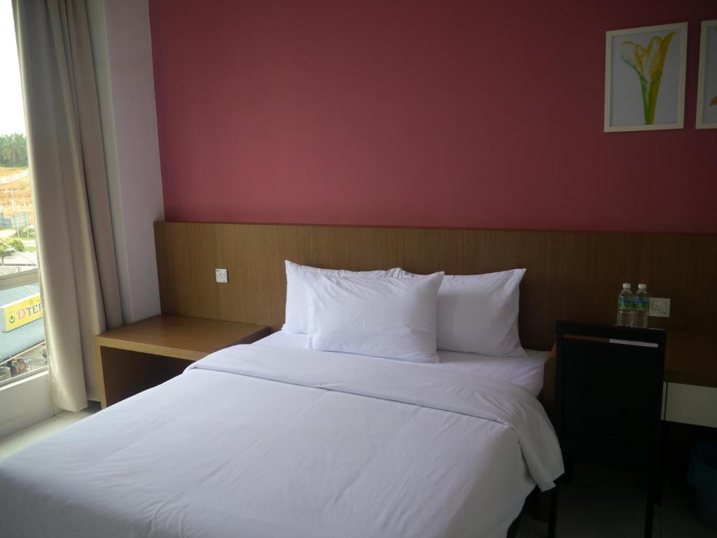 Postel nebo postele na pokoji v ubytování Hotel Wawasan