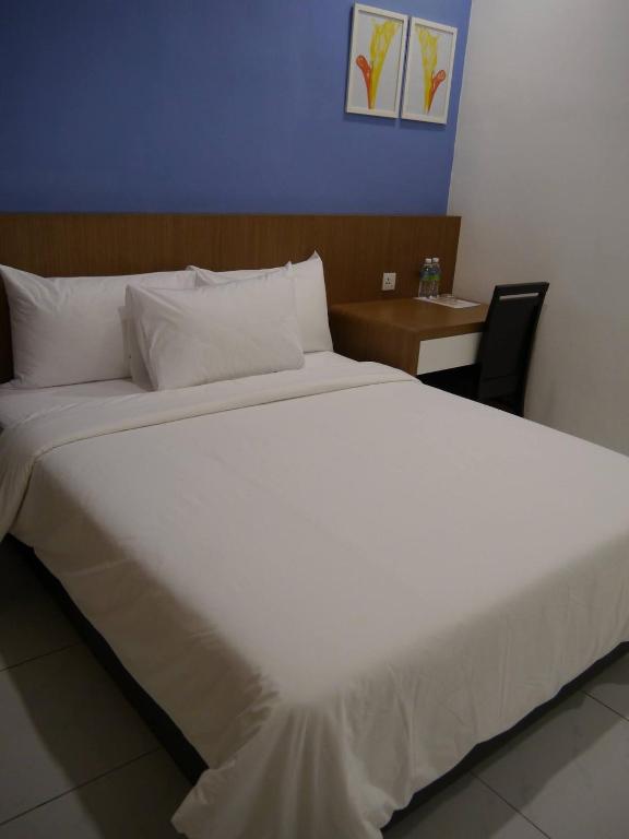 Postel nebo postele na pokoji v ubytování Hotel Wawasan