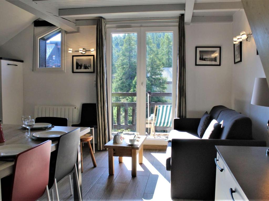 uma sala de estar com um sofá e uma mesa em Appartement Risoul, 1 pièce, 6 personnes - FR-1-330-506 em Risoul