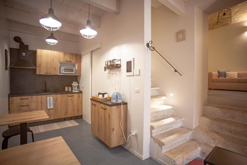 a kitchen with stairs and a dining room and a kitchen with at Sistò Petite Maison in Altamura